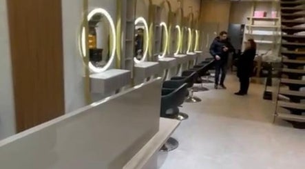 Modern interior of Salon Charles Malek, Naqqache, Jabal Lubnan, LB with sleek styling stations and illuminated mirrors.