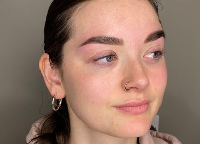 Close-up of a woman showcasing expertly shaped eyebrows at Masha Beauty Room, London, England, GB.