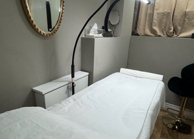 Tranquil treatment room at Masha Beauty Room in London, England, GB with a plush bed and modern decor.