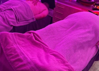 Relaxing massage setup at Eden Hair & Beauty, Heywood, England, GB under calming purple lighting.