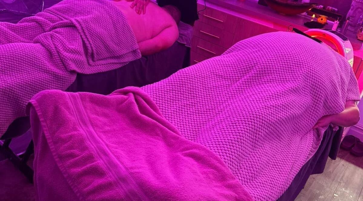 Relaxing massage setup at Eden Hair & Beauty, Heywood, England, GB under calming purple lighting.