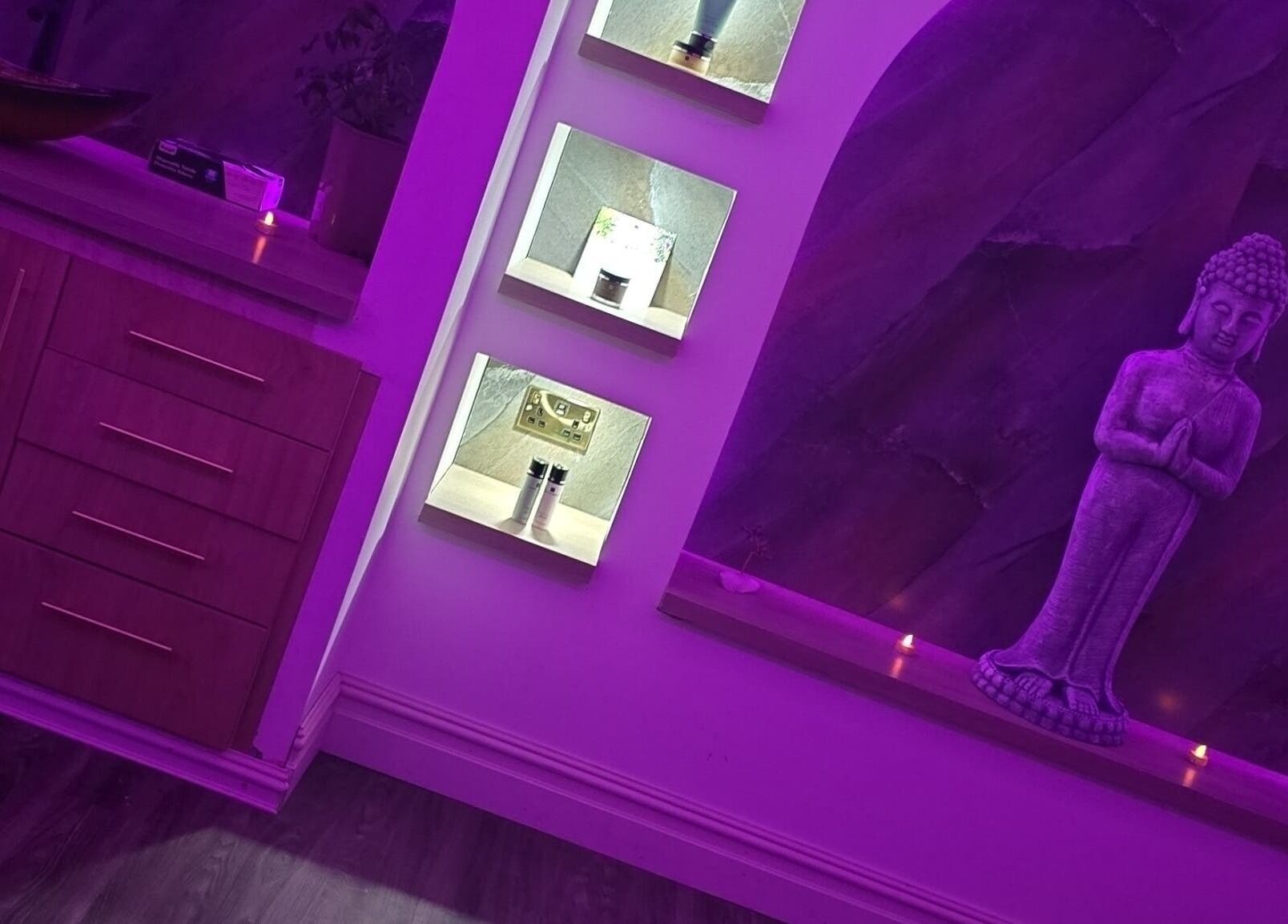 Relaxing spa ambiance with purple lighting and Buddha statue at Eden Hair & Beauty, Heywood, England, GB.