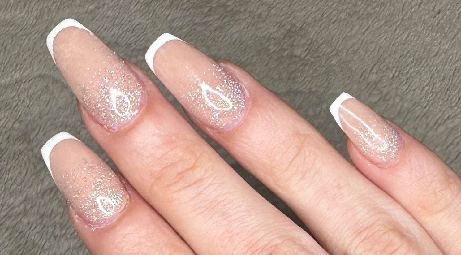 Glittery French manicure at Glow Nails, Dublin, County Dublin, IE featuring elegant and sparkling nail art.