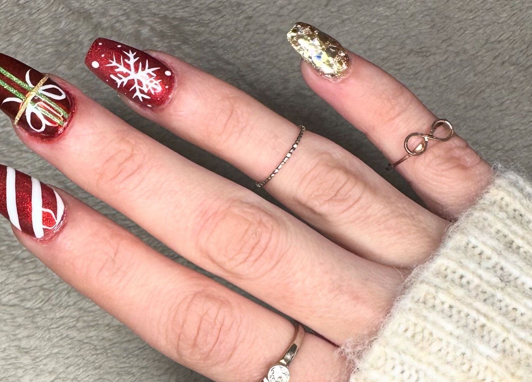 Festive nail art from Glow Nails, Dublin, County Dublin, IE showcasing red and white holiday-themed designs.