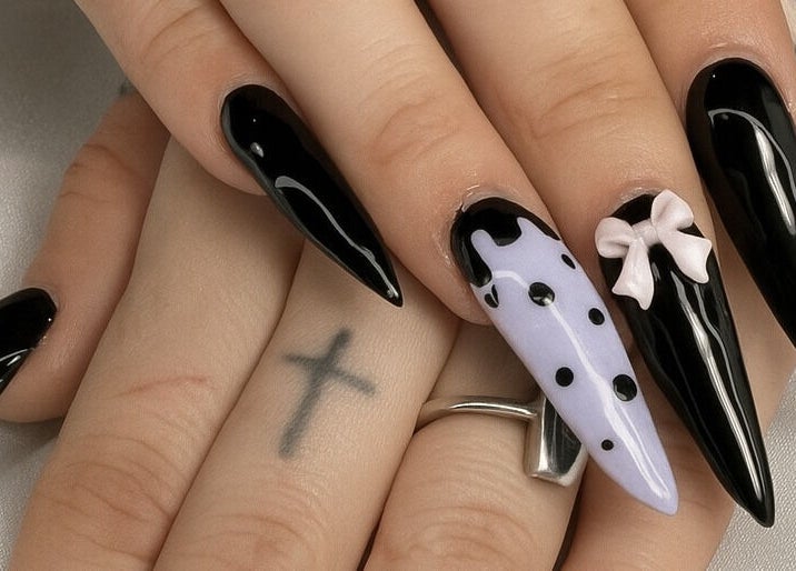 Chic black and lilac polka dot nails with a bow design at Glow Nails, Dublin, County Dublin, IE.
