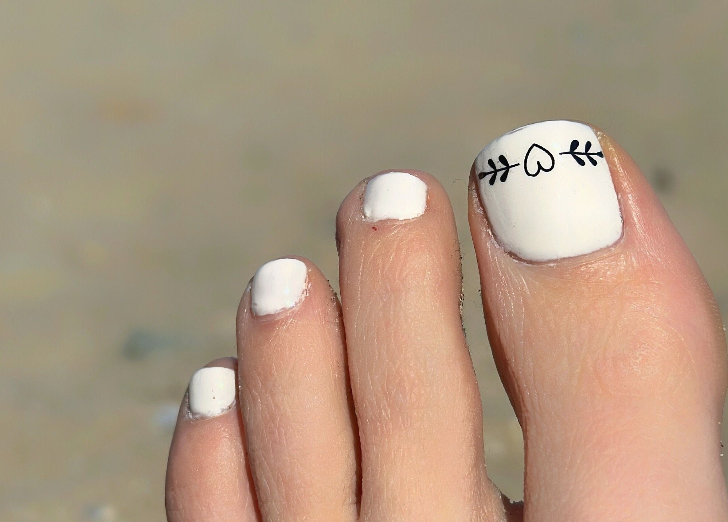 Stylish white toe nail art at Glow Nails, Dublin, County Dublin, IE, showcasing intricate design.