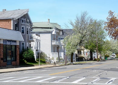 View of Shape Nails on a sunny street in Medford, Massachusetts, US, featuring a vibrant neighborhood.