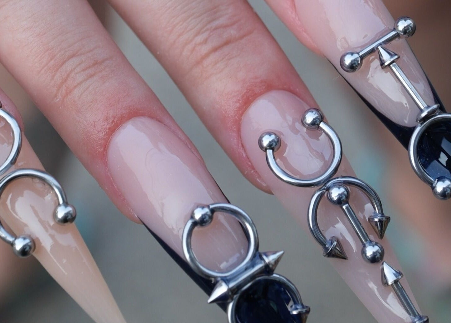 Unique nail art with metallic adornments at Shape Nails Medford, located in Medford, Massachusetts, US.