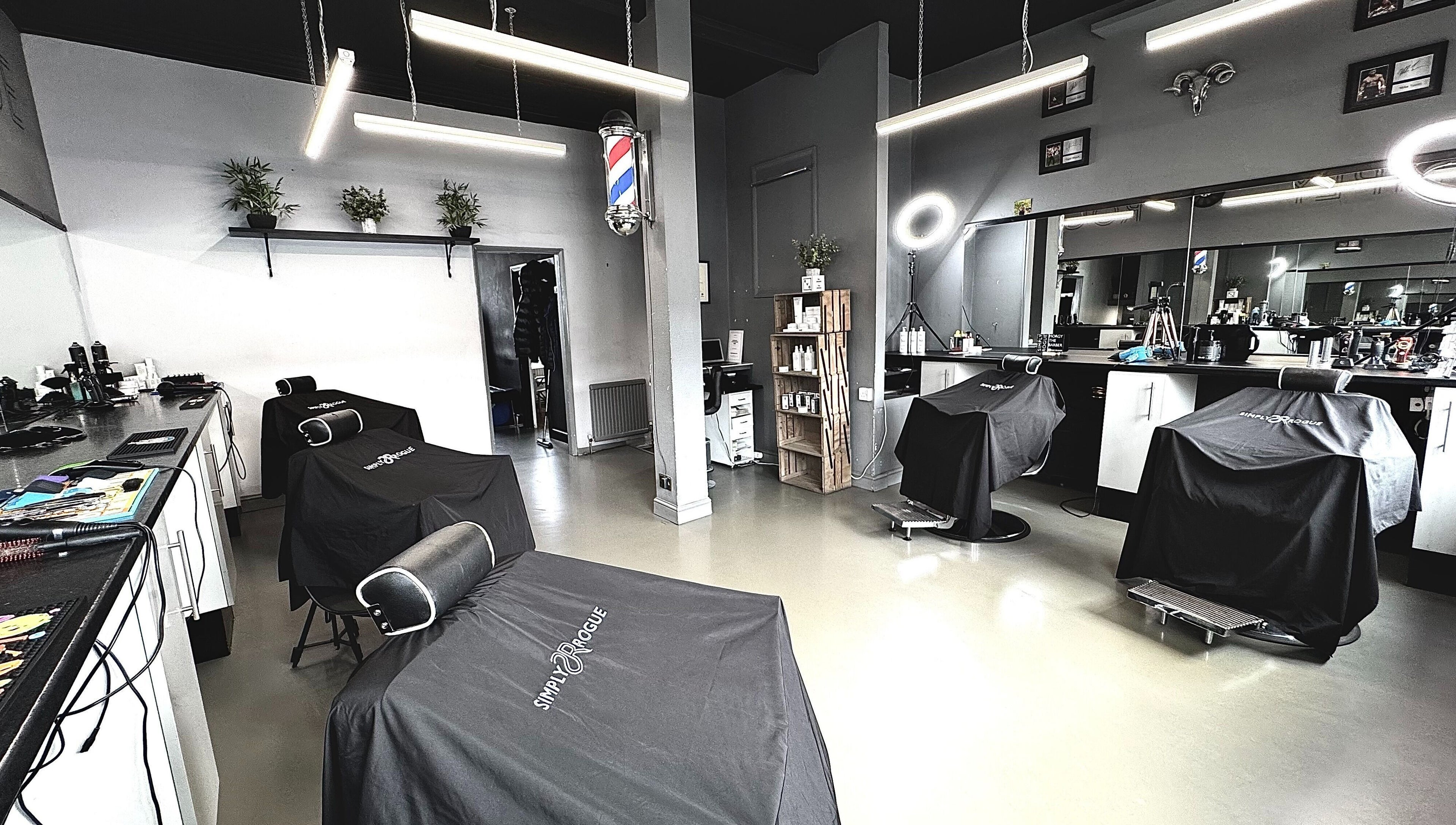Interior of Simply Rogue salon, Darlington, England, showcasing modern barber chairs and classy decor.