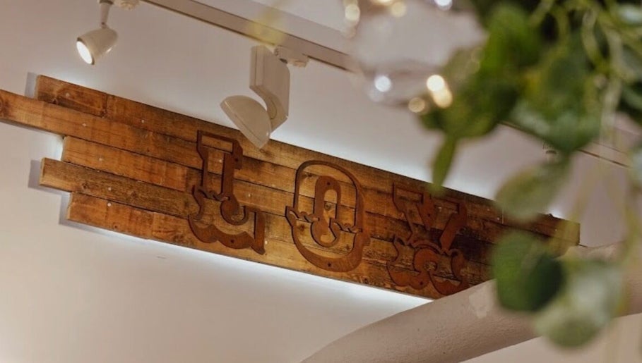 Aster Beauty's wooden 'Joy' sign in Fakenham, England, GB, adds a rustic touch to the venue's decor.