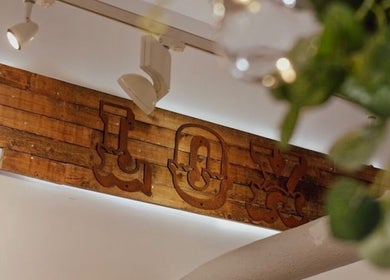 Aster Beauty's wooden 'Joy' sign in Fakenham, England, GB, adds a rustic touch to the venue's decor.
