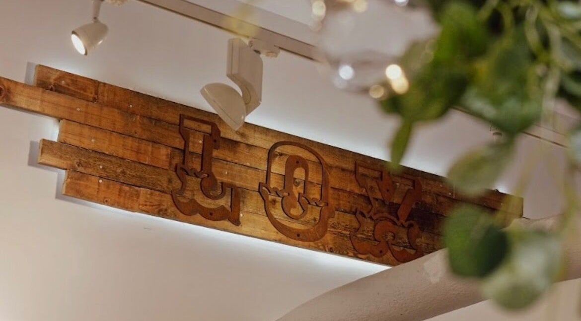 Aster Beauty's wooden 'Joy' sign in Fakenham, England, GB, adds a rustic touch to the venue's decor.