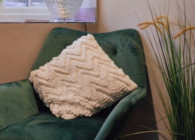Relaxing green chair with a textured pillow at Aster Beauty, Fakenham, England, GB.