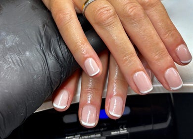 Elegant French manicure at Aster Beauty, Fakenham, England, GB. Perfectly groomed nails highlighting refined style.