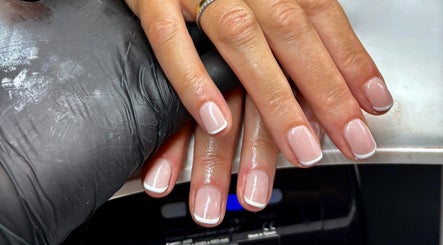 Elegant French manicure at Aster Beauty, Fakenham, England, GB. Perfectly groomed nails highlighting refined style.