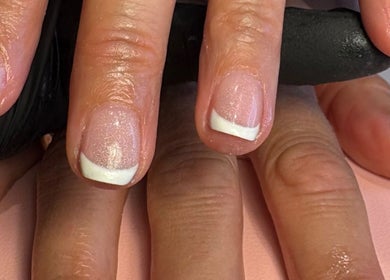 Elegant French manicure at Aster Beauty, Fakenham, England, GB showcasing glossy pink and white nails.