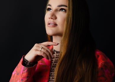 Elegant woman at Glamtime Iza Jeronim in Hull, England, GB, gazing upward, showcasing beauty and style.