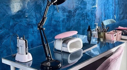 Modern nail station at Alexander Beauty and Training Academy in Irvine, Scotland, GB, featuring tools and a lamp.