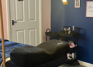 Relaxing treatment room at Alexander Beauty and Training Academy, Irvine, Scotland, GB, featuring a massage bed.
