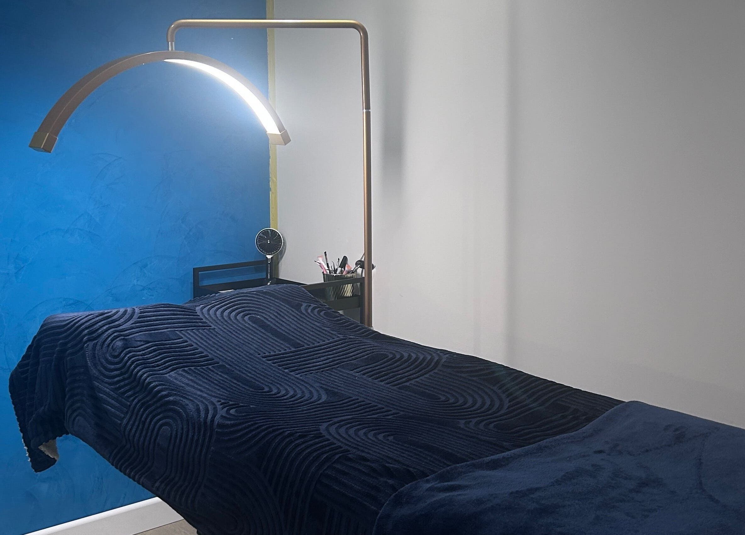 Relaxing treatment room at Alexander Beauty and Training Academy, Irvine, Scotland, GB with modern decor and ambient lighting.