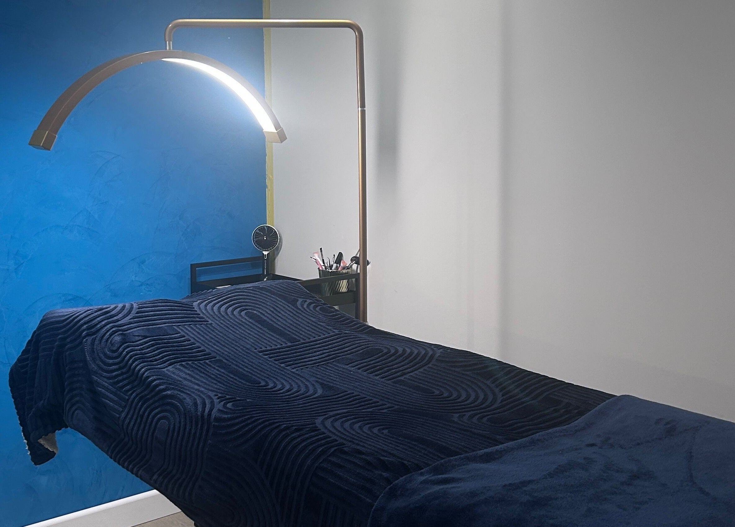 Relaxing treatment room at Alexander Beauty and Training Academy, Irvine, Scotland, GB with modern decor and ambient lighting.