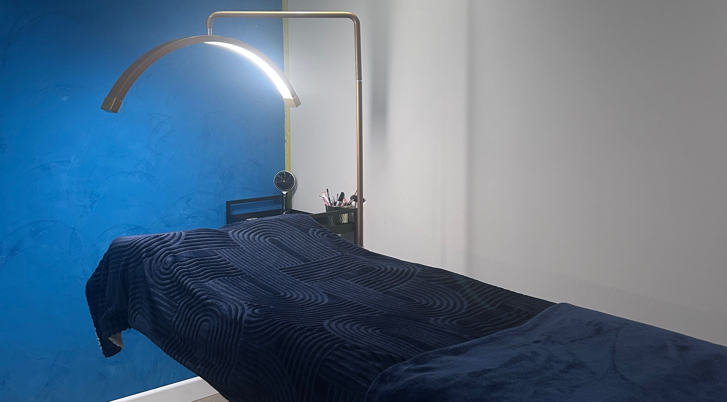 Relaxing treatment room at Alexander Beauty and Training Academy, Irvine, Scotland, GB with modern decor and ambient lighting.