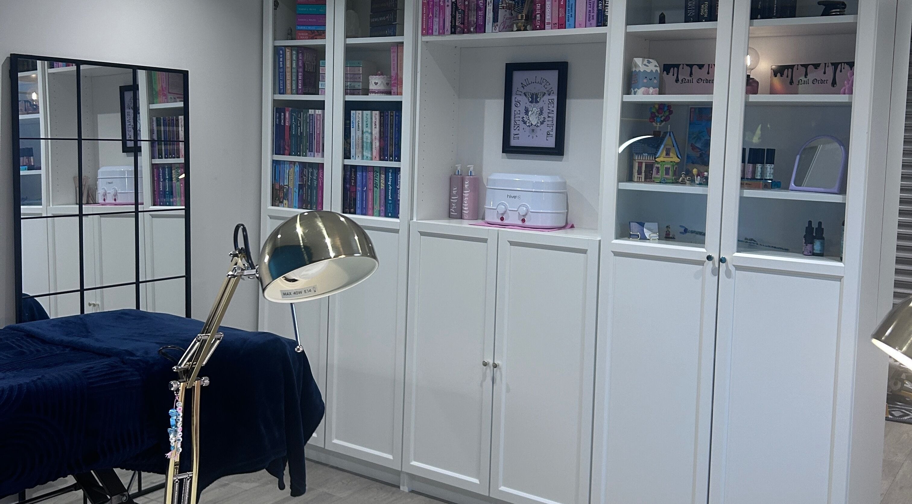 A serene beauty room at Alexander Beauty and Training Academy, Irvine, Scotland, GB, with elegant shelving.