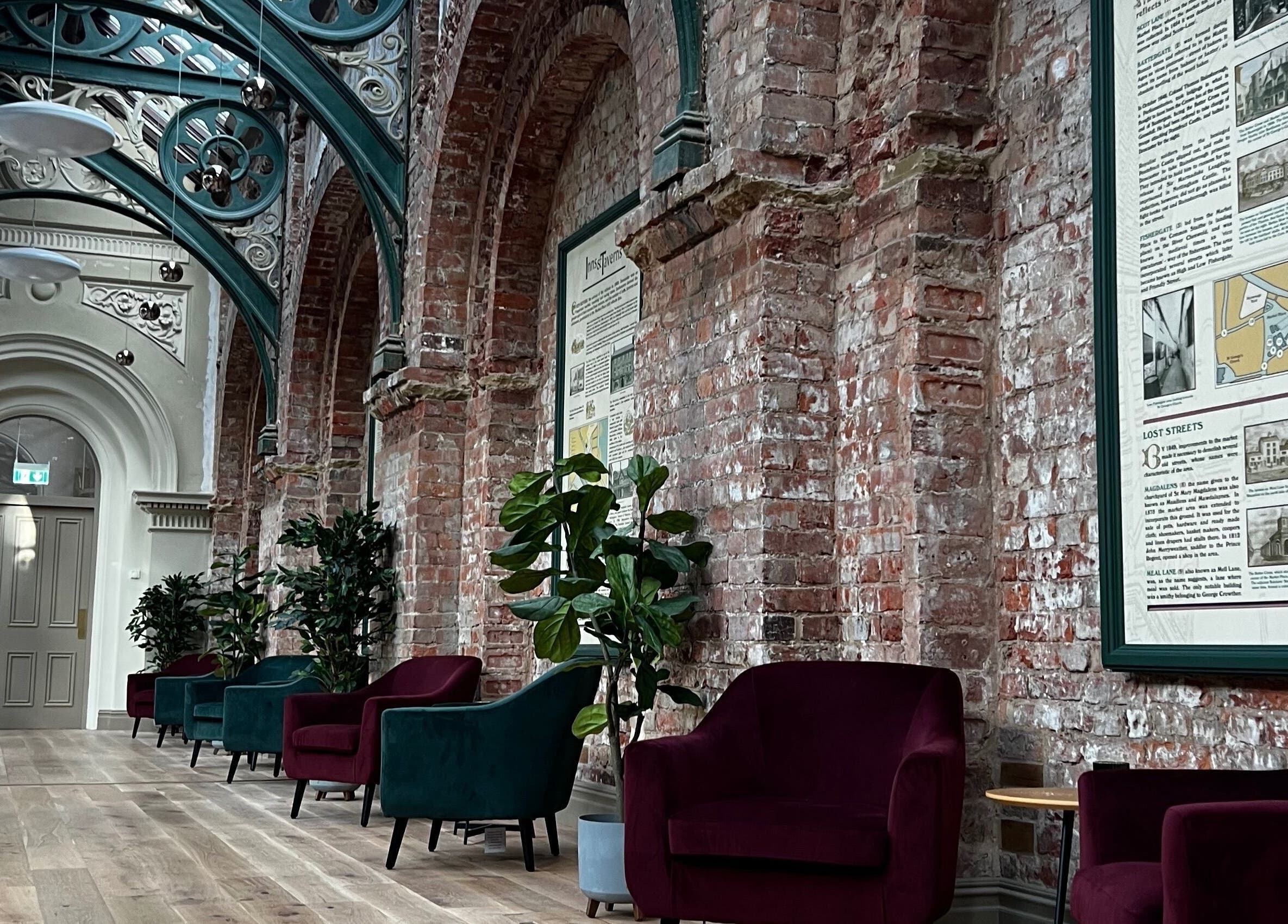Stylish interior at Klsandco, Doncaster, England, GB with elegant seating and rustic brick walls.