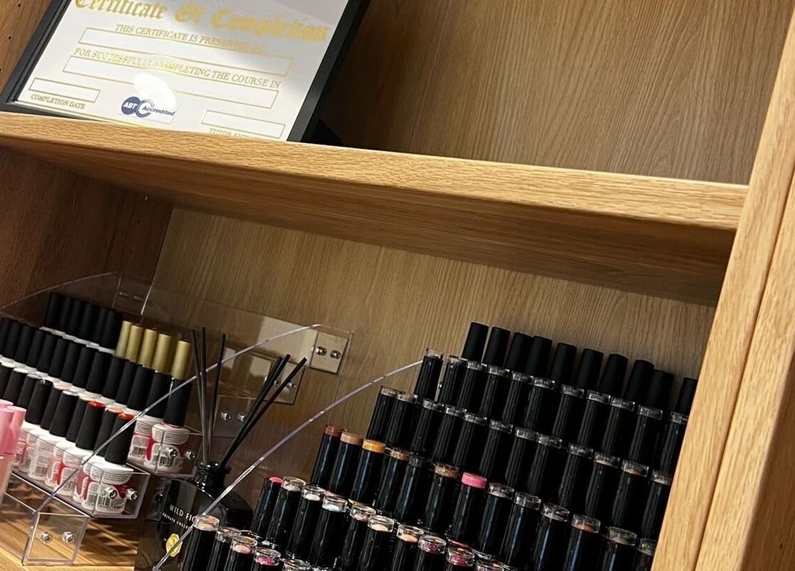 Nail polish collection at Klsandco, Doncaster, England, GB, showcasing vibrant colors on wooden shelves.