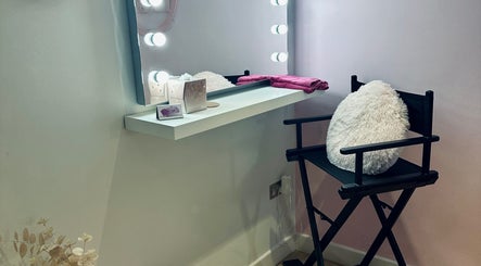 Makeup studio at Lux by Kristina, Cheltenham, England, GB, featuring a lit vanity and cozy chair.