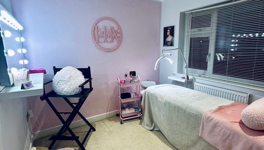 Elegant treatment room at Lux by Kristina, Cheltenham, England, GB with pastel decor and plush seating.