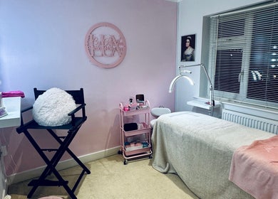 Elegant treatment room at Lux by Kristina, Cheltenham, England, GB with pastel decor and plush seating.