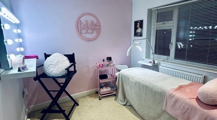 Elegant treatment room at Lux by Kristina, Cheltenham, England, GB with pastel decor and plush seating.