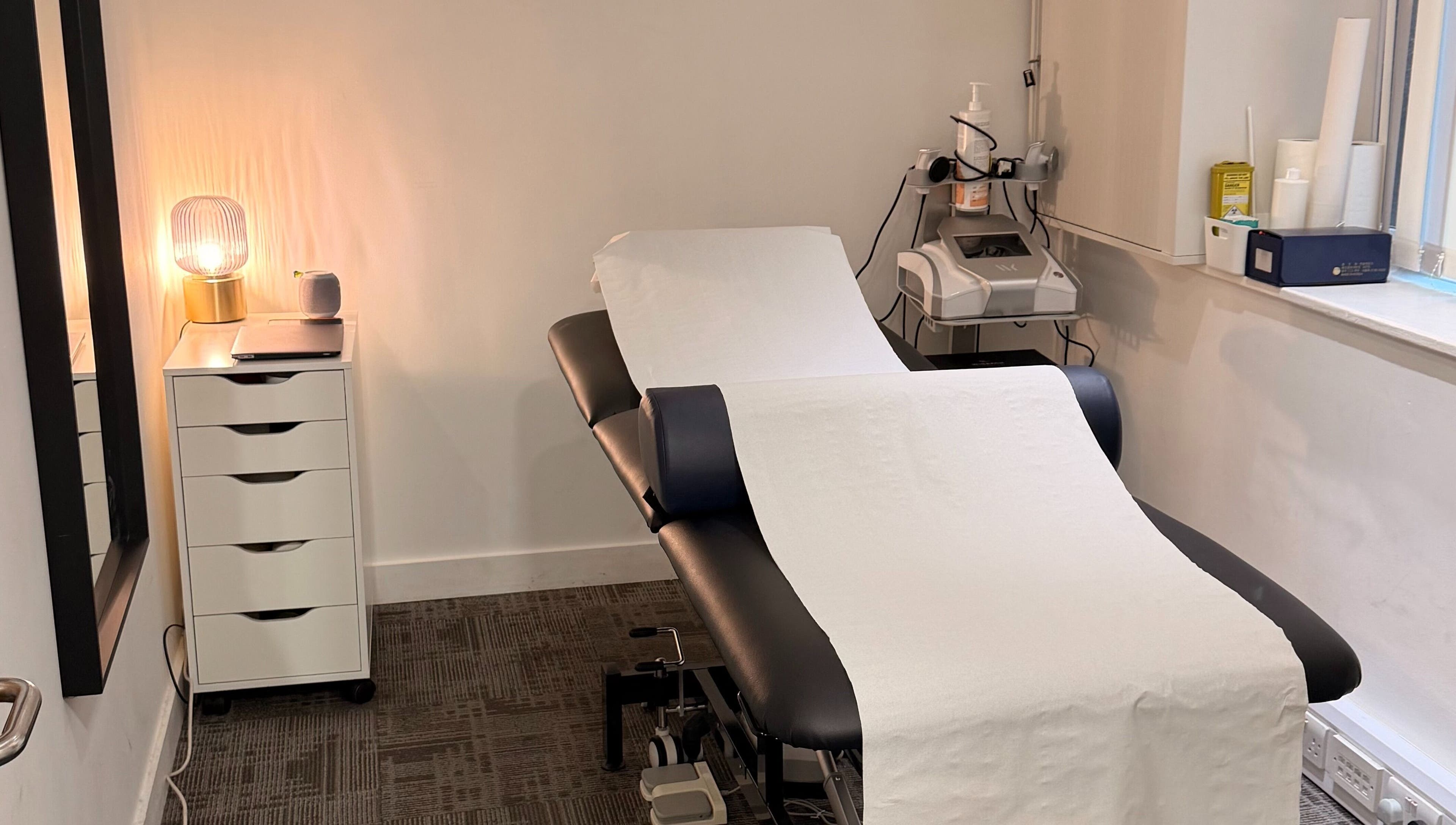 Comfortable treatment room at Seventeen Physiotherapy Clinic, London, England, GB with an adjustable therapy bed.