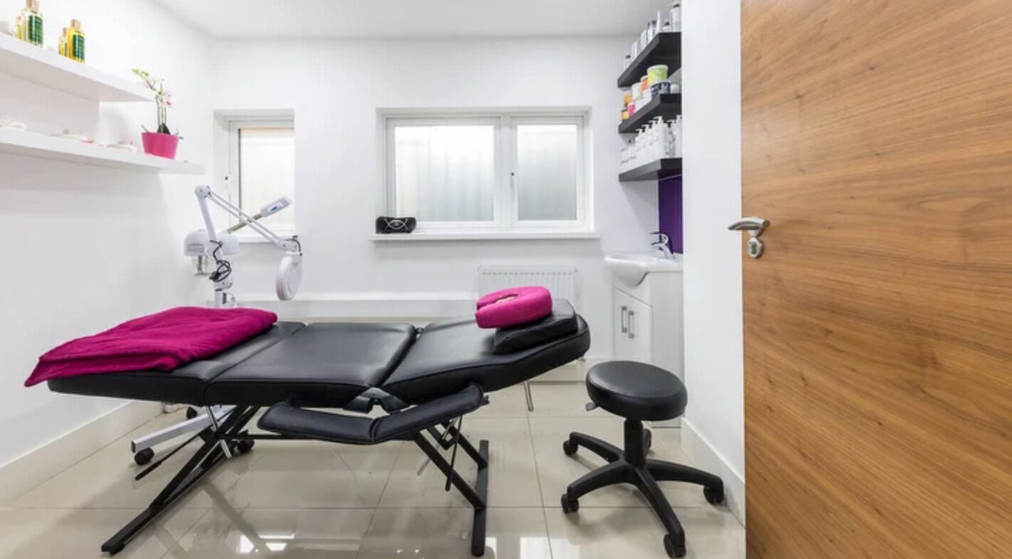 Serene treatment room at BEAUTÉ Hair & Beauty, London, England, GB, featuring modern equipment and cozy decor.