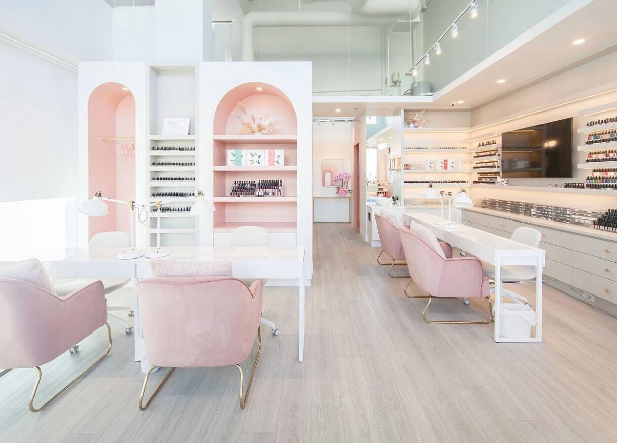 Chic nail salon at JJ Fantasy World, Richmond, British Columbia, CA featuring pink chairs and polish displays.