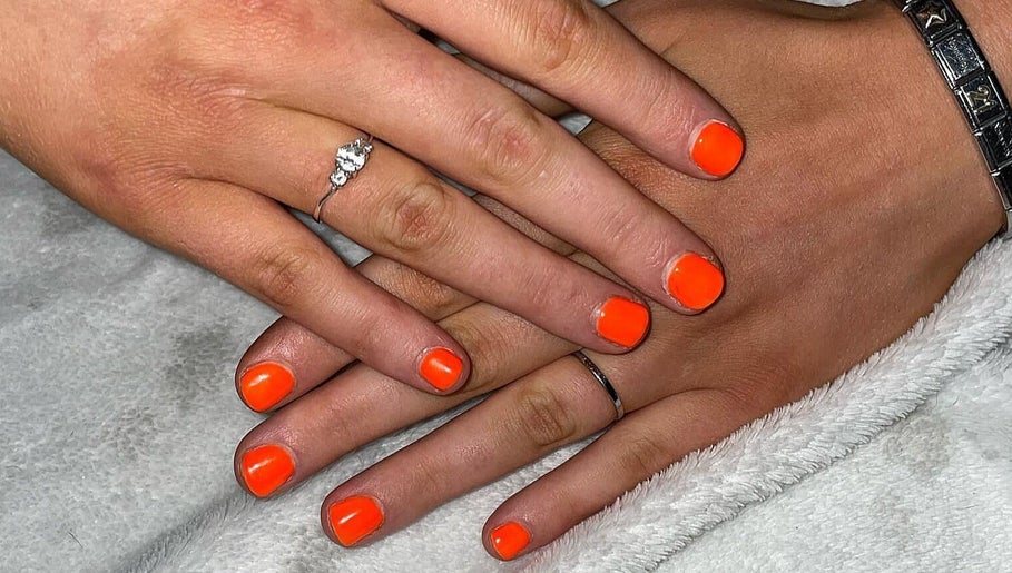Bright orange manicure showcasing nail artistry at Khloes Beauty Room, Belfast, Northern Ireland, GB.