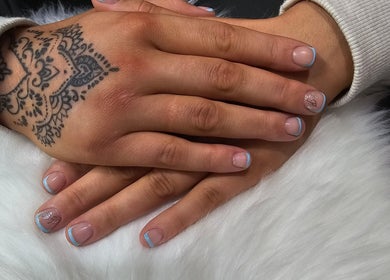 Nail art with blue tips and tattoo design at Khloes Beauty Room, Belfast, Northern Ireland, GB.