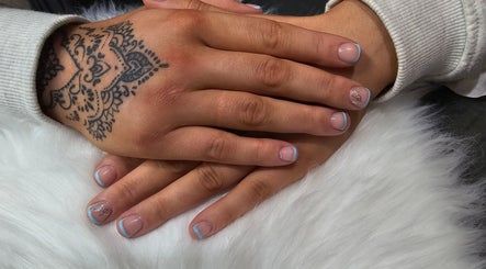 Nail art with blue tips and tattoo design at Khloes Beauty Room, Belfast, Northern Ireland, GB.