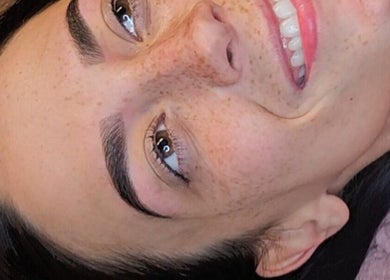 A woman with perfectly groomed eyebrows smiling at Khloes Beauty Room, Belfast, Northern Ireland, GB.
