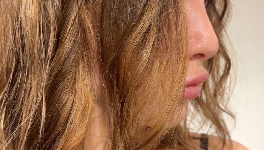 Close-up of styled hair at High Fashion Salon, Par, England, GB showcasing vibrant, healthy locks.