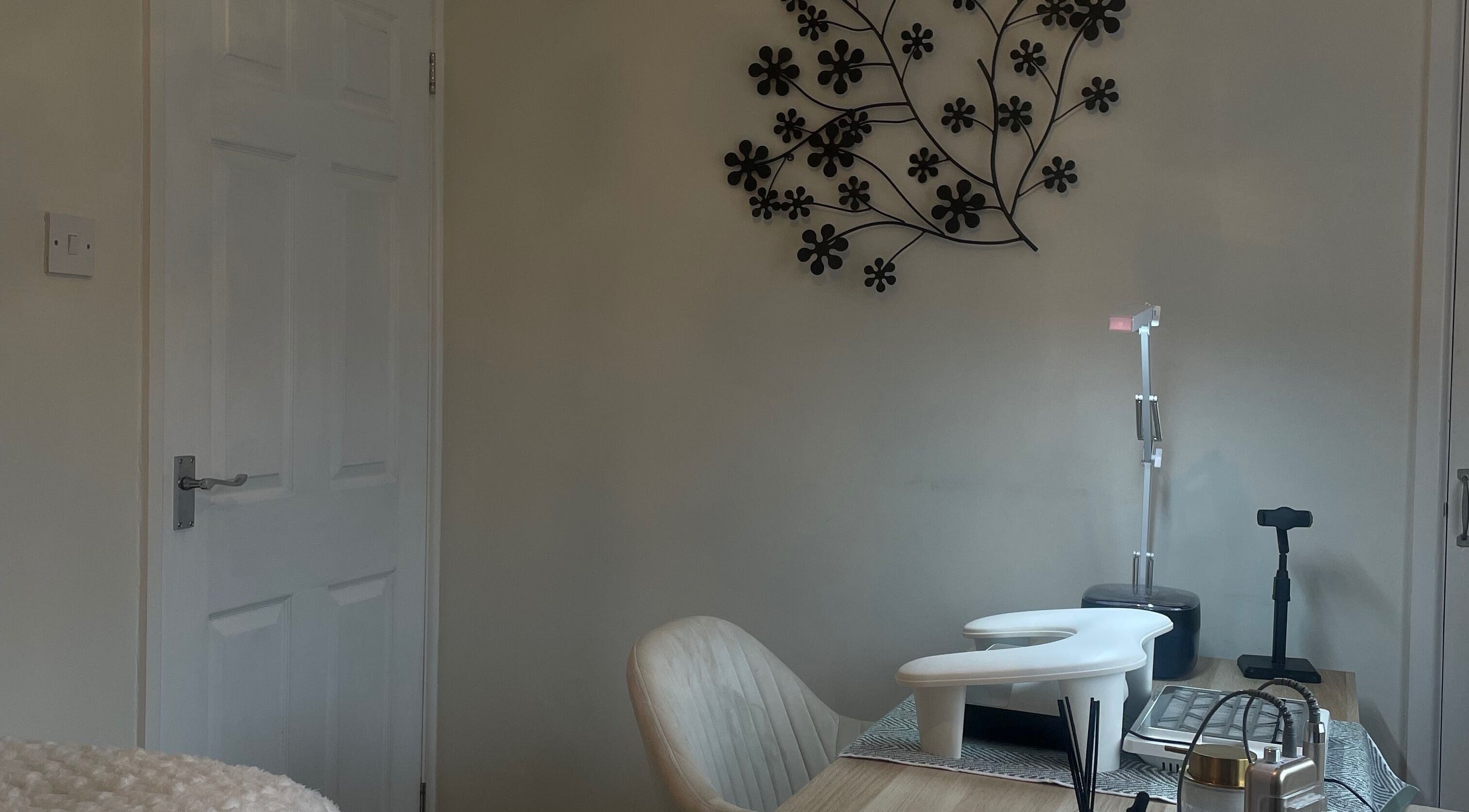 Cozy salon space at Amy Rose Nails, Barnstaple, England, GB with a manicure table and floral wall art.