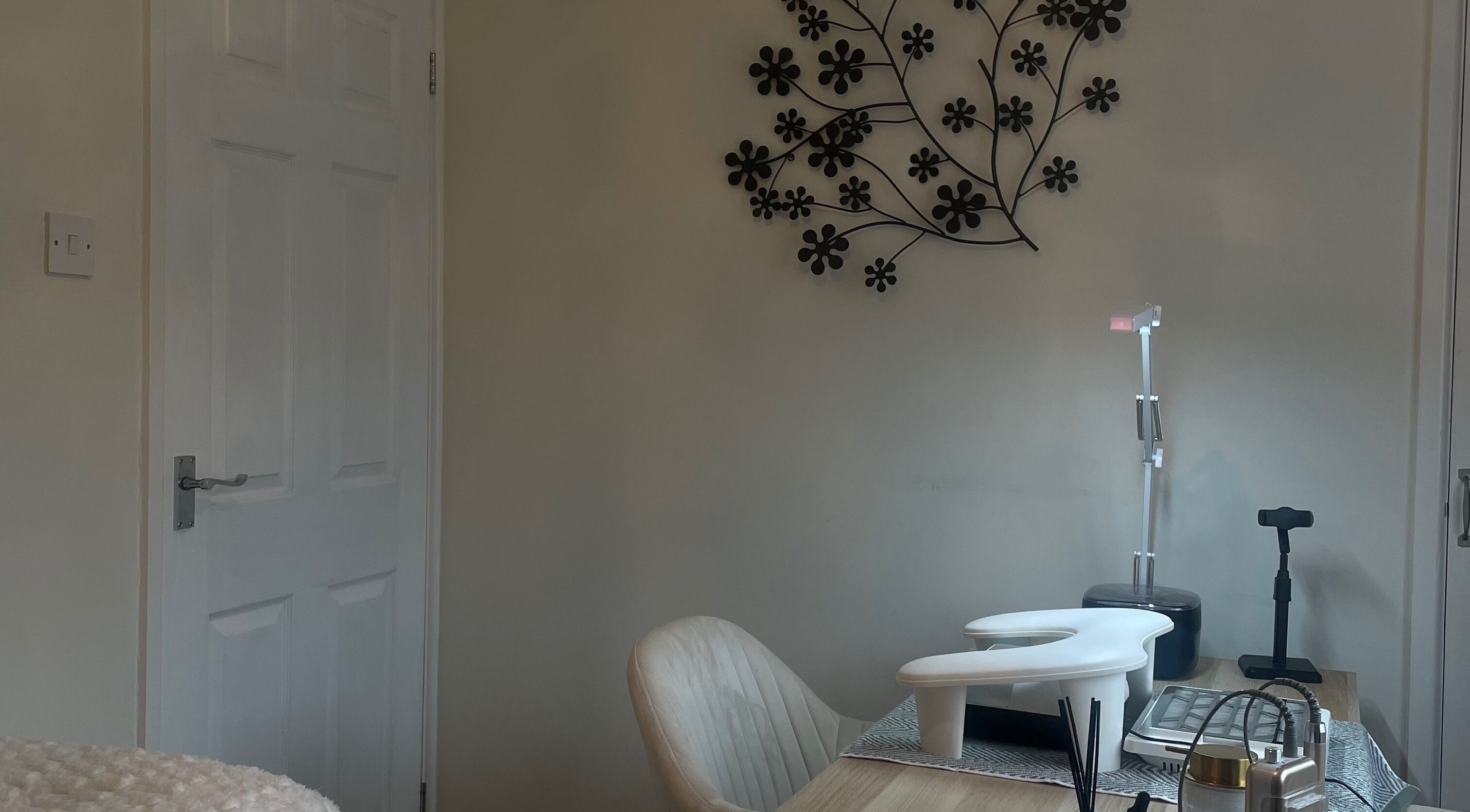 Cozy salon space at Amy Rose Nails, Barnstaple, England, GB with a manicure table and floral wall art.
