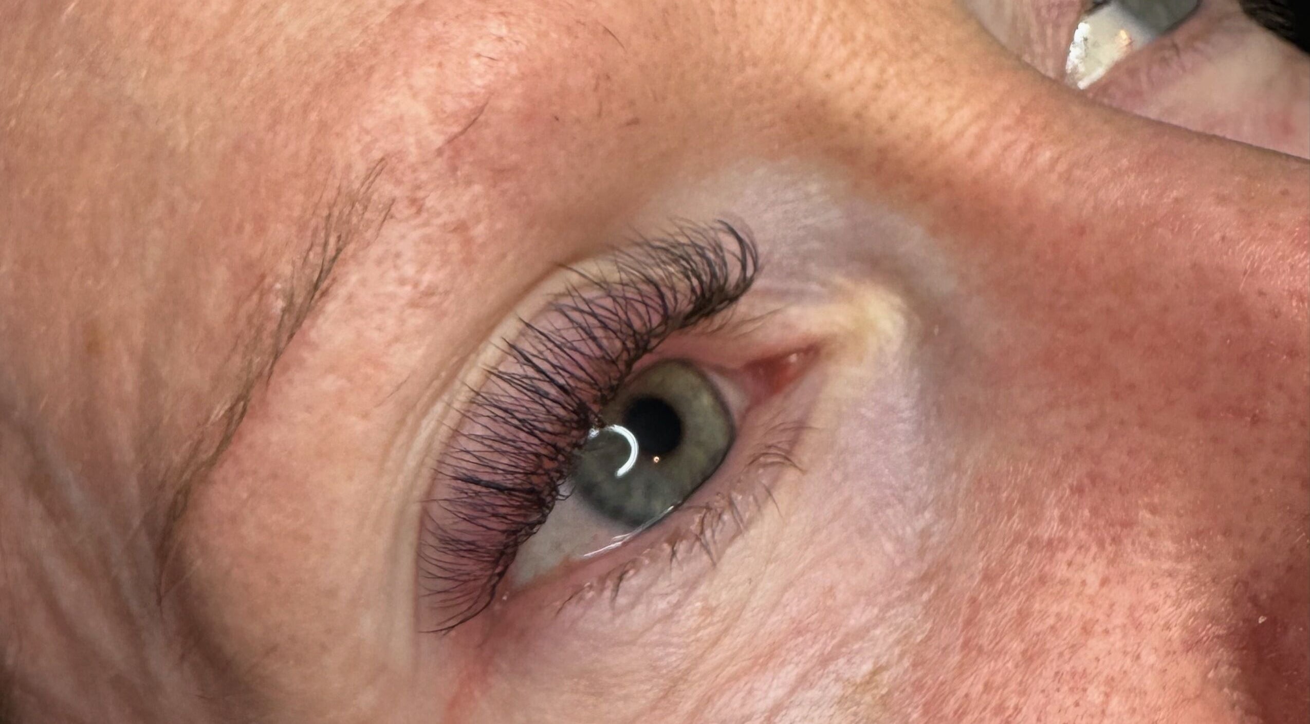 Close-up of eye with elegant eyelash extensions at WattsBeauty, Rushden, England, GB.