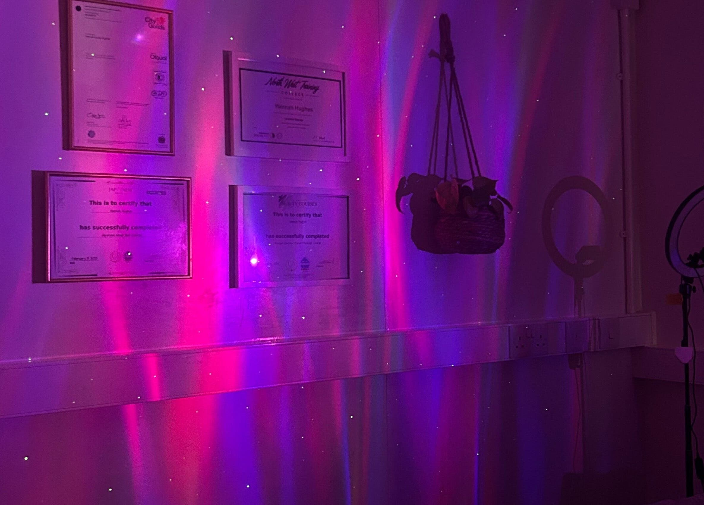 Calming purple ambiance at Vibes Head Spa, Birkenhead, England, GB showcasing certificates and decor.