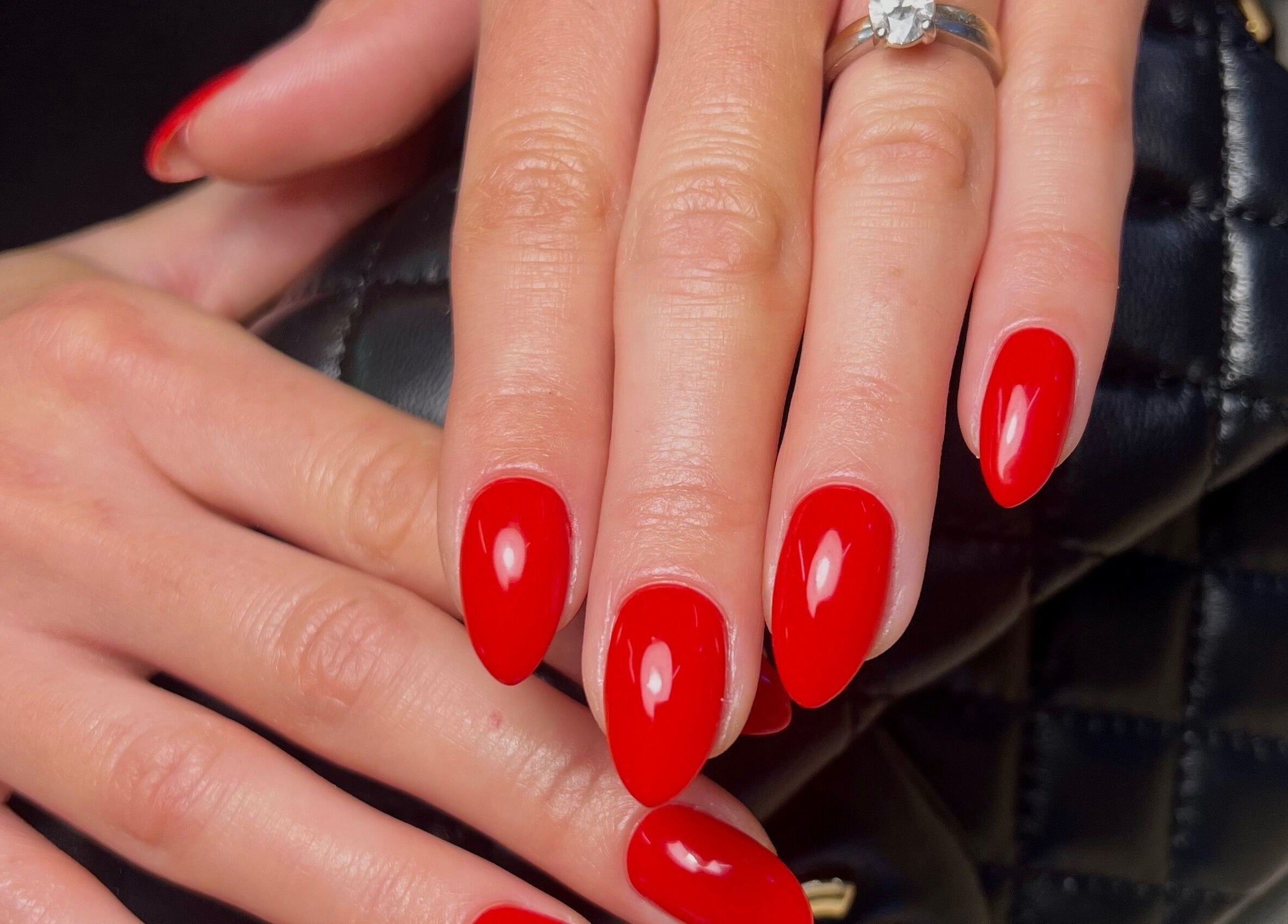 Red manicured nails at Painted by Jane, Lerwick, Scotland, GB, showcasing elegant nail art.