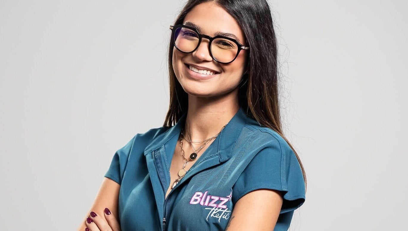 Smiling staff at Blizzthetic in San Juan, San Juan, PR, wearing uniform and glasses.