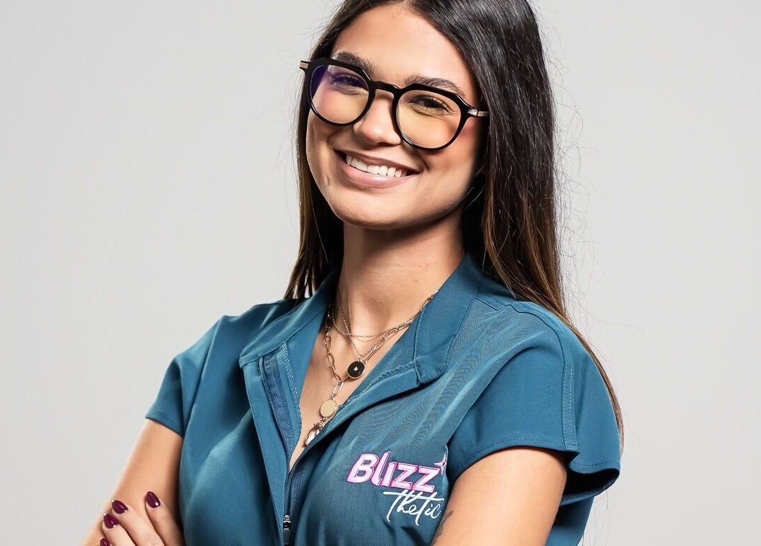 Smiling staff at Blizzthetic in San Juan, San Juan, PR, wearing uniform and glasses.