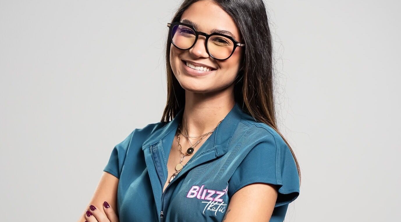 Smiling staff at Blizzthetic in San Juan, San Juan, PR, wearing uniform and glasses.