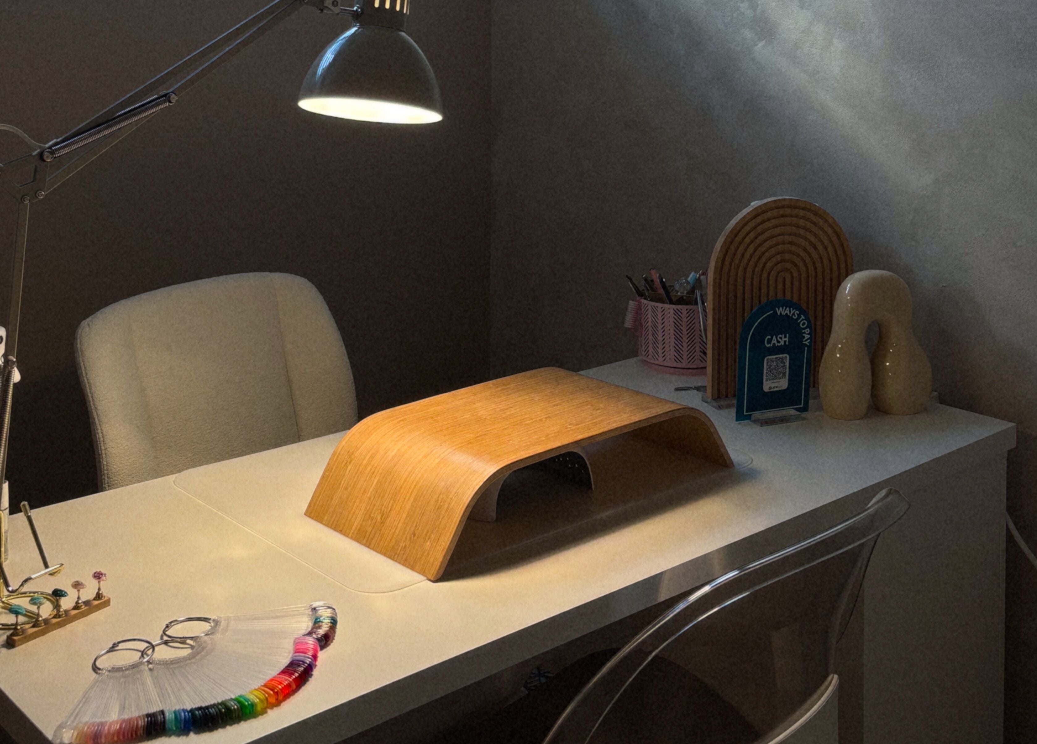 Cozy nail station at Blizzthetic, San Juan, PR featuring a lamp and manicure tools.